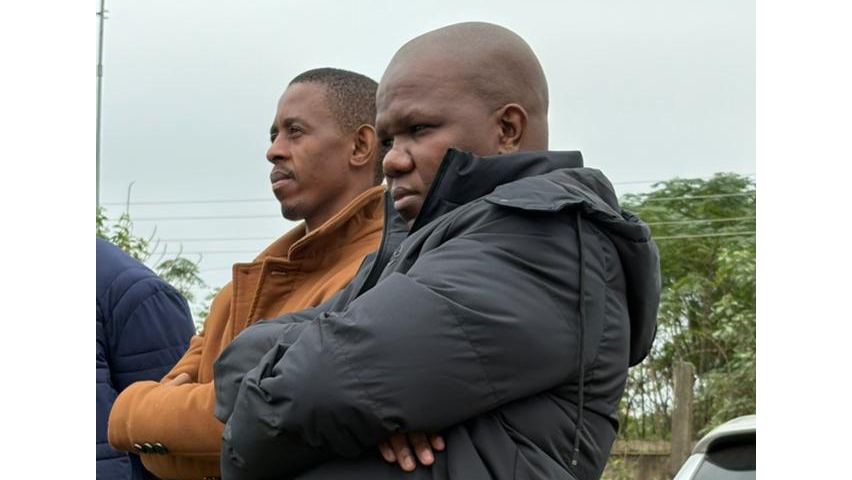Themba Dumsani Dlamini and his Lawyer Simo Simelane look on as court officials inspect the detained vehicle presented as part of the State’s evidence.
